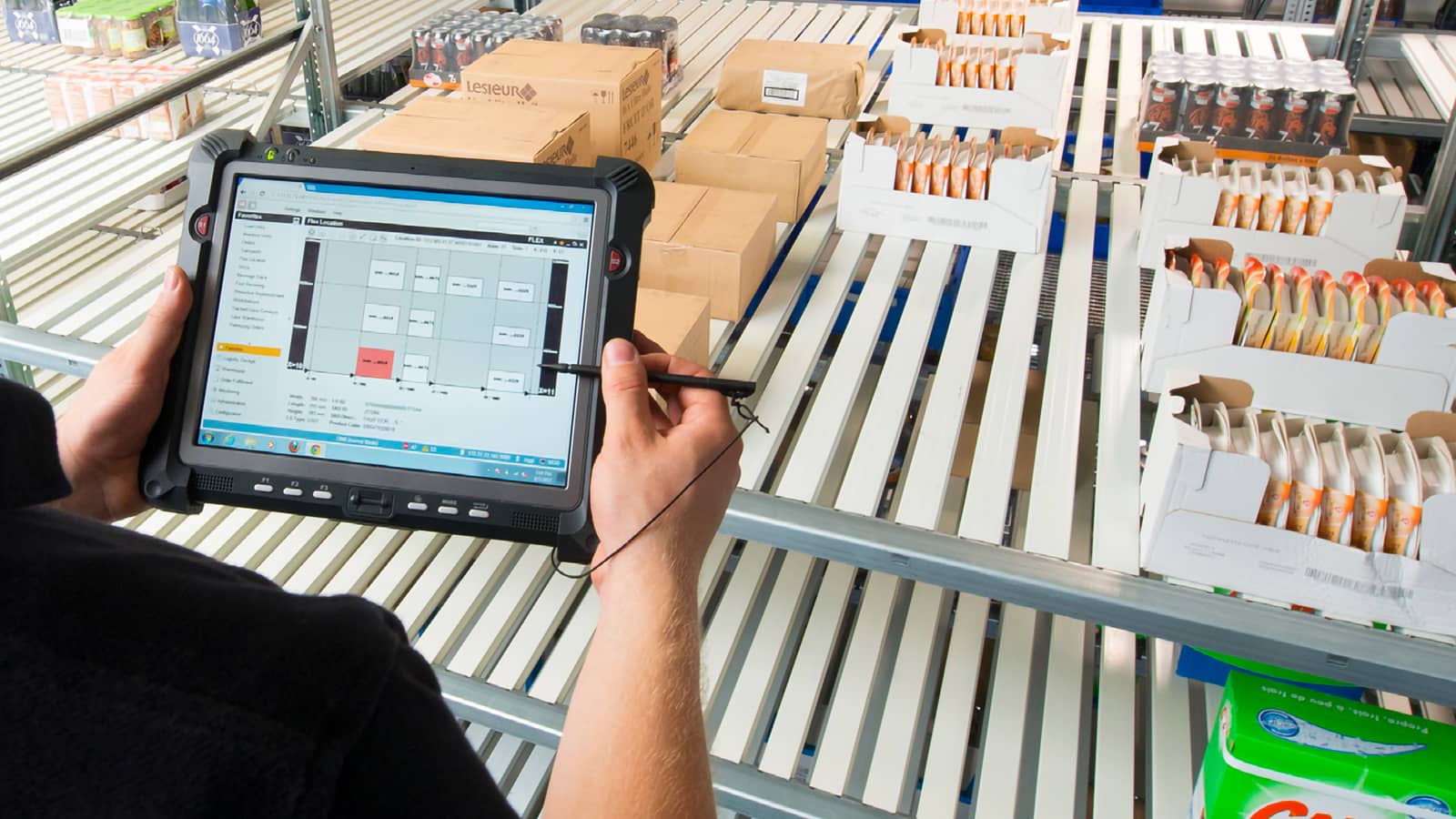 Male hands taking inventory of goods on tablet